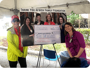 Cara and Pam in front of check presentation